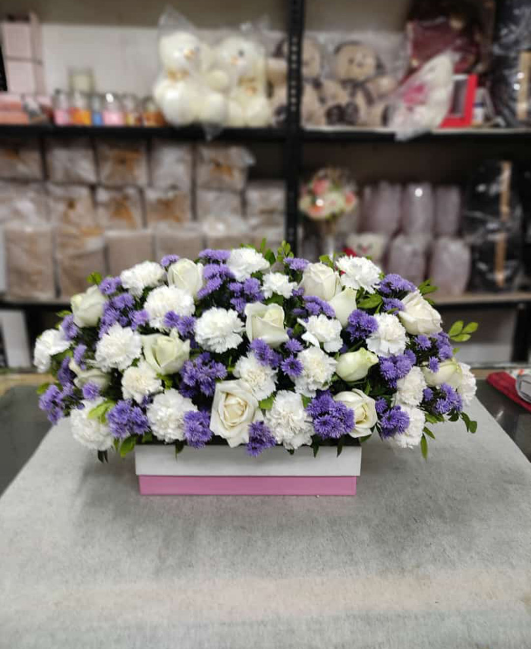 30 White Carnation And Roses With Blue Daisy Wreath Arrangement