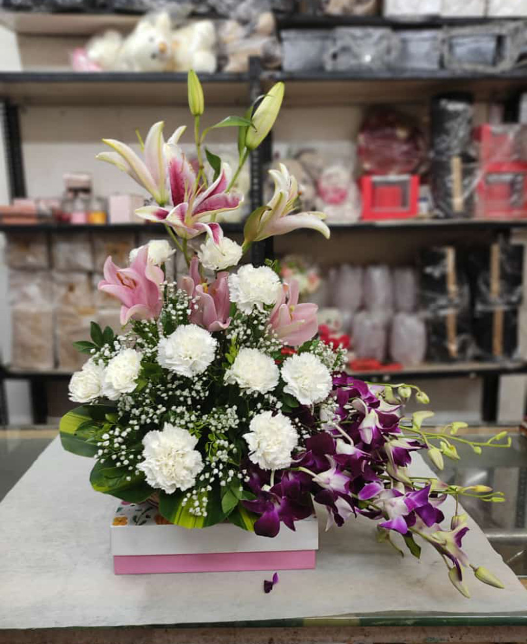 Basket of 2 Pink Lilies, 10 White Carnation And 10 Purple Orchids